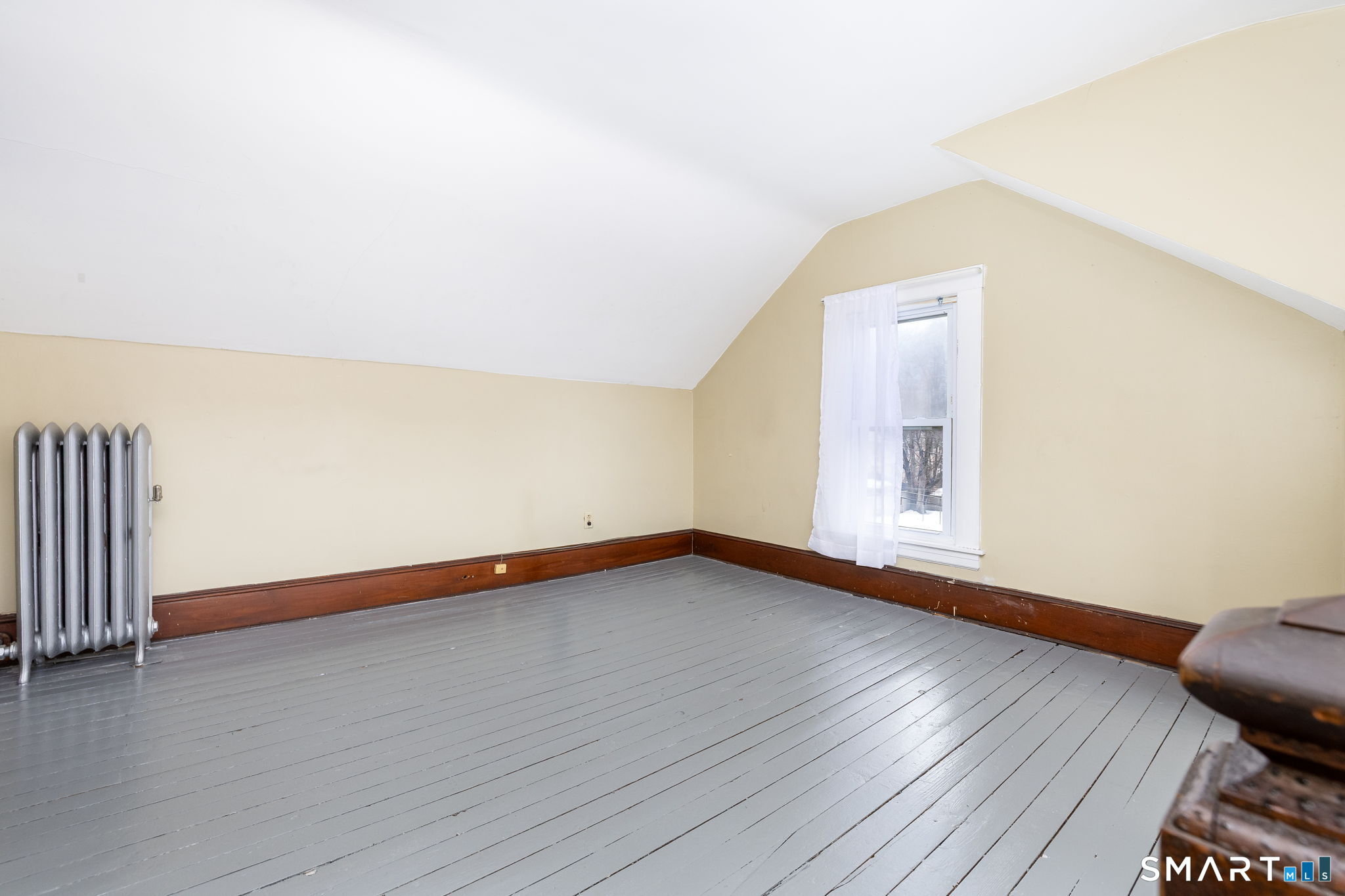 41 Walnut Street Enfield, CT 06082 - Photo 23 of 38 a view of an empty room with wooden floor and a window