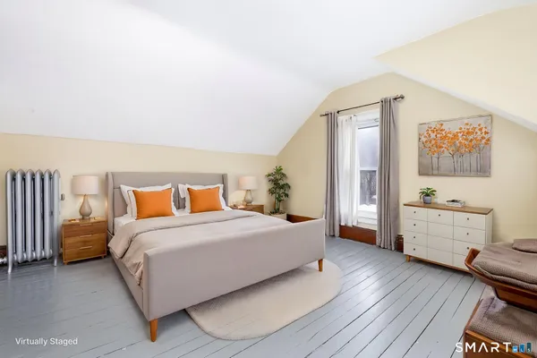 a bedroom with a bed and a dresser