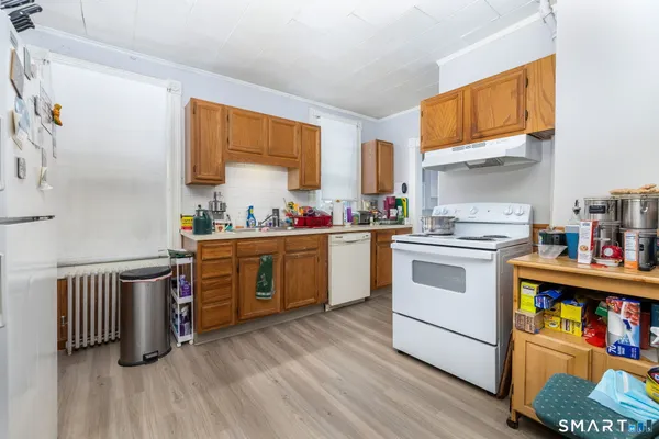 a kitchen with a sink cabinets and wooden floor