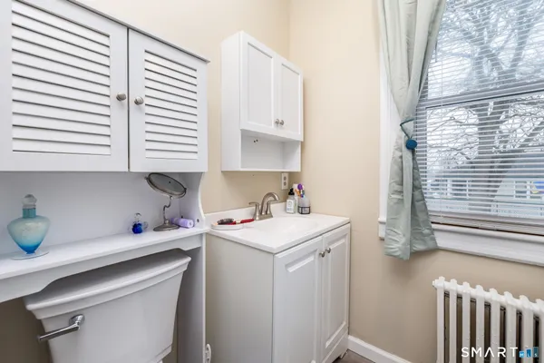 a view of a kitchen with a sink a microwave and cabinets