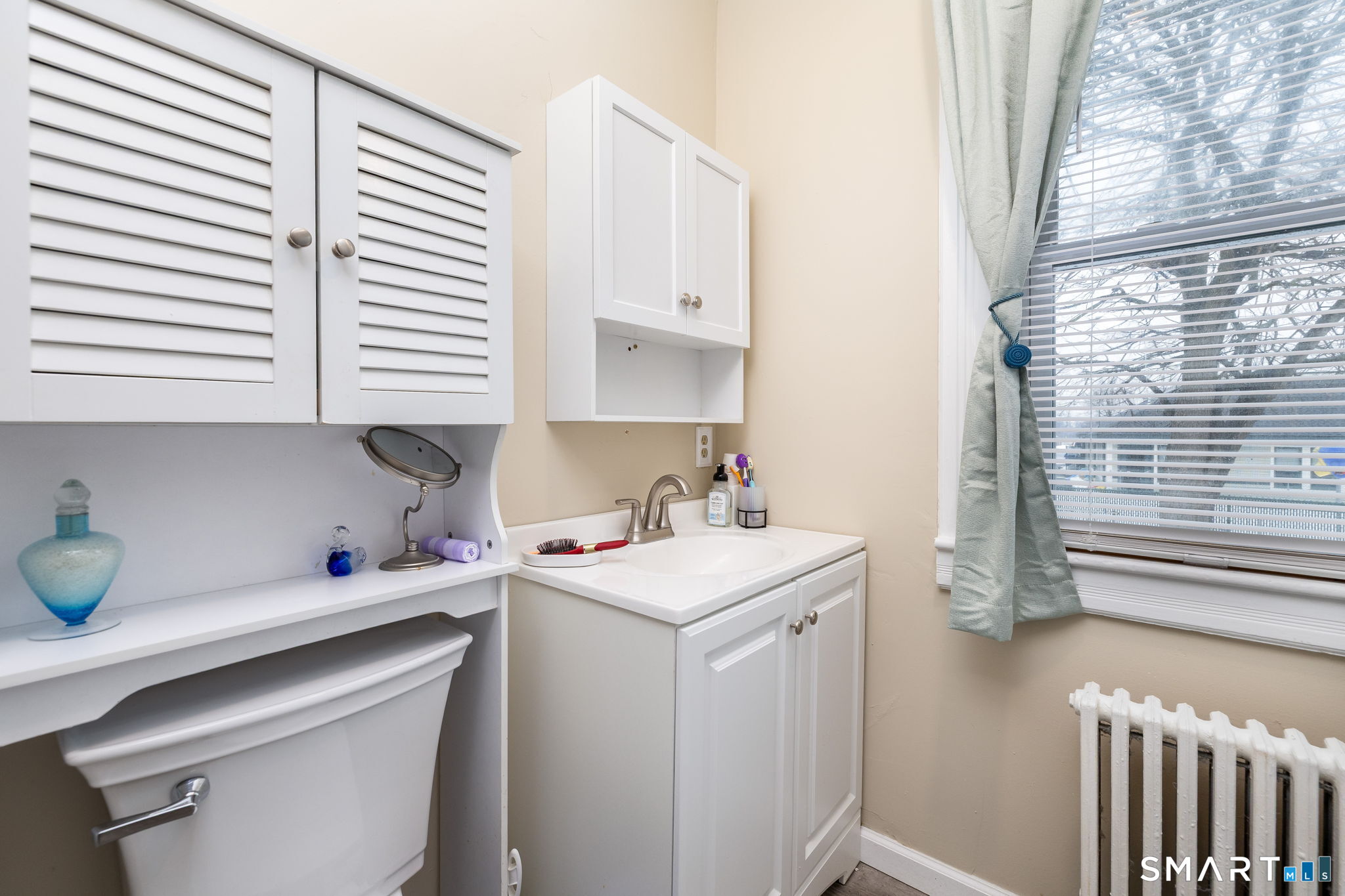 41 Walnut Street Enfield, CT 06082 - Photo 28 of 38 a view of a kitchen with a sink a microwave and cabinets