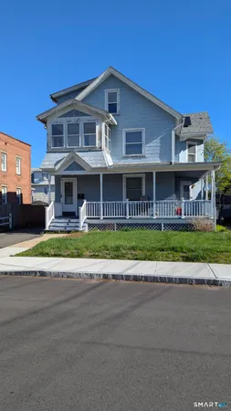 a front view of building with yard and green space