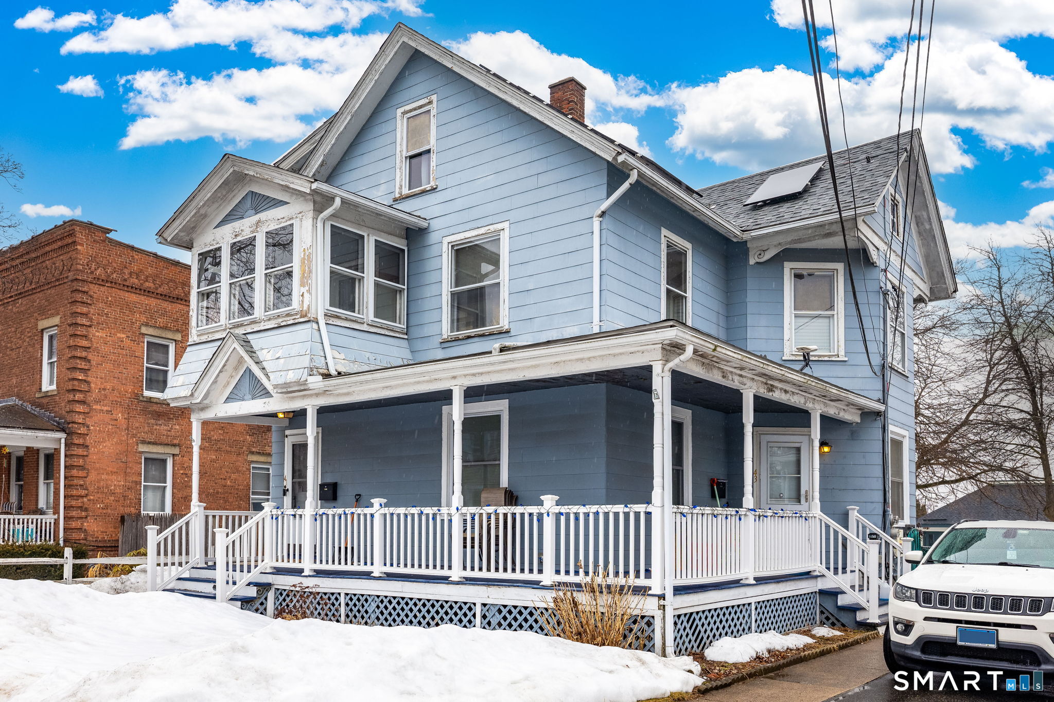 41 Walnut Street Enfield, CT 06082 - Photo 35 of 38 a view of a white house with large windows and a tree