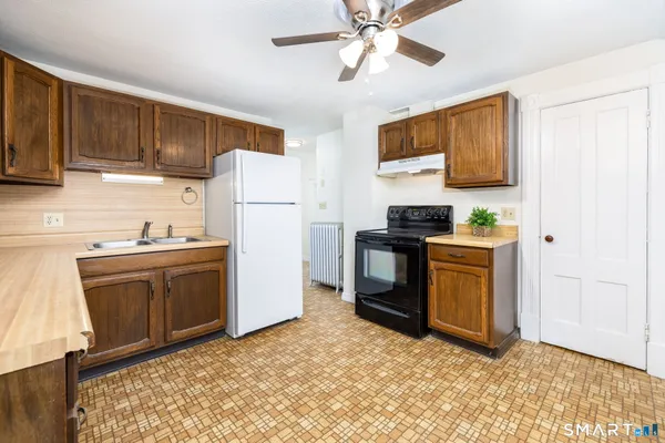 a kitchen with a refrigerator sink and stove
