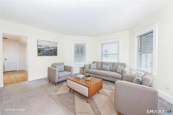 a living room with furniture and a window