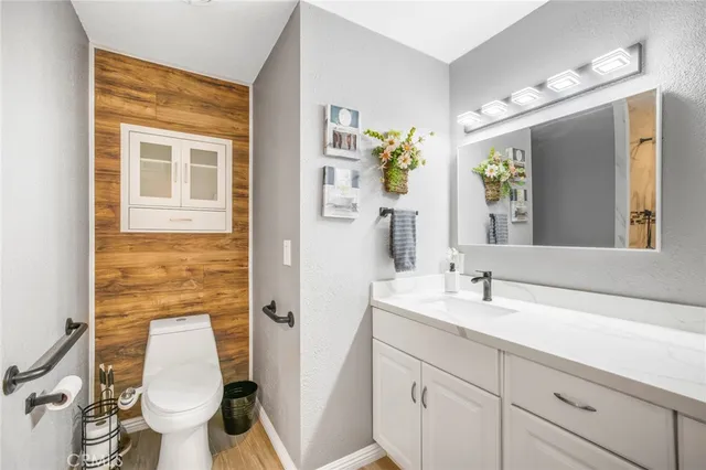 a bathroom with a sink and mirror with toilet