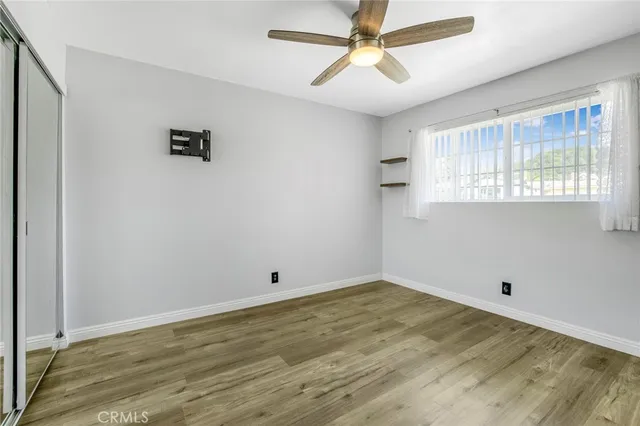 a view of a livingroom with a window and a ceiling fan