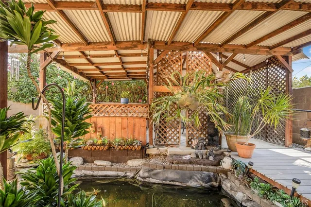 a view of swimming pool with outdoor seating and plants