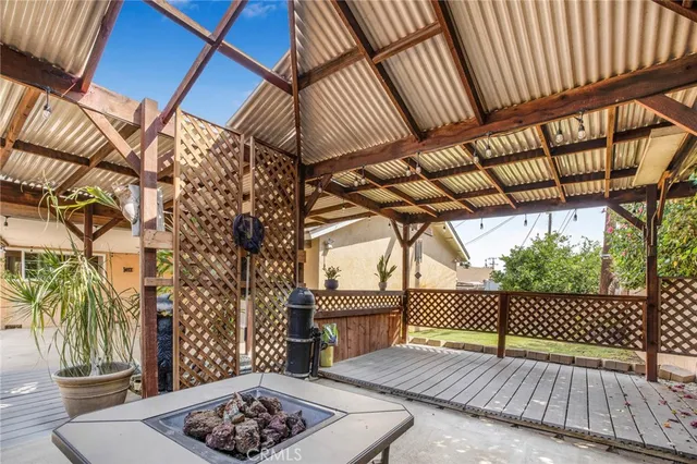 a roof deck with table and chairs under an umbrella