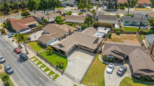 an aerial view of a house with a swimming pool and outdoor seating