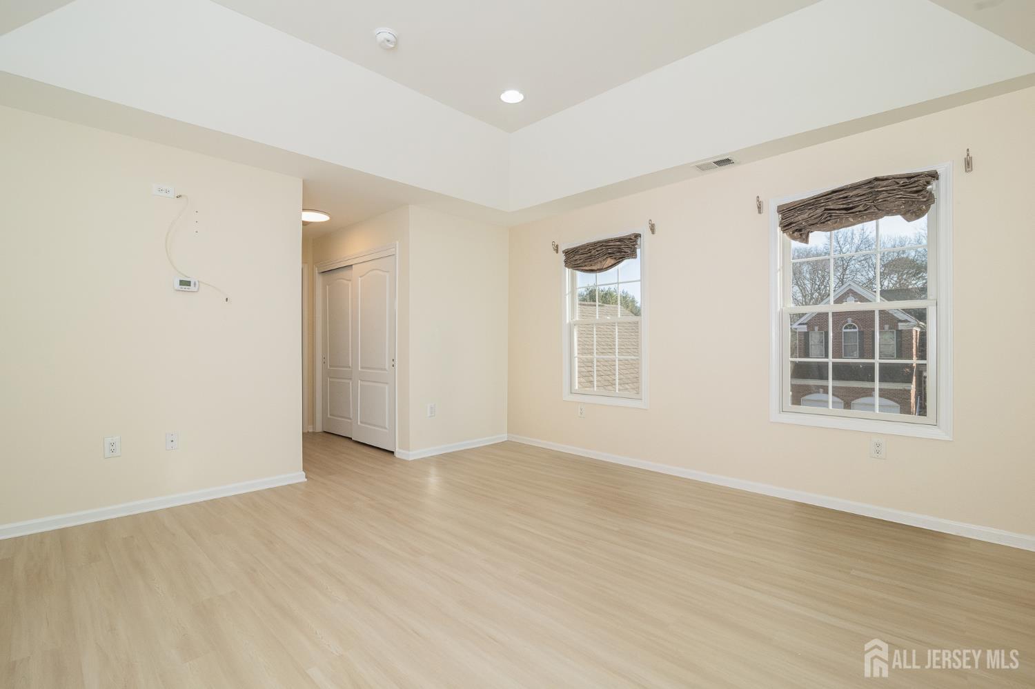 4 Timber Grove Court Old Bridge, NJ 08857 - Photo 12 of 20 an empty room with wooden floor and windows