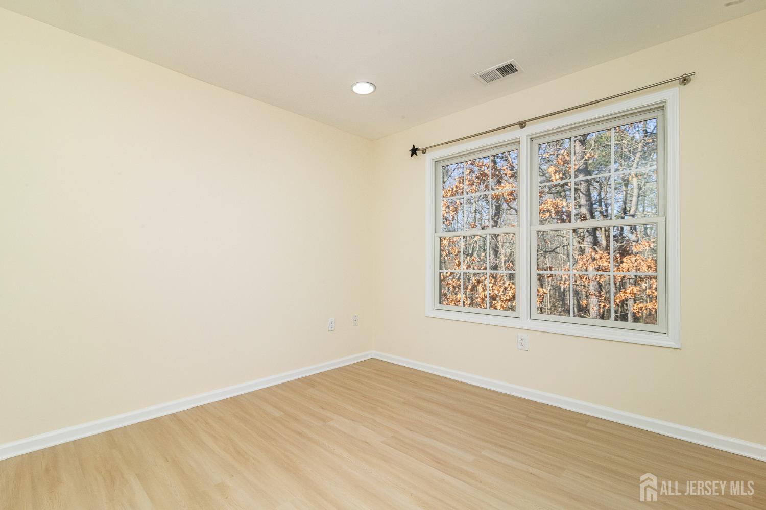 4 Timber Grove Court Old Bridge, NJ 08857 - Photo 13 of 20 a view of an empty room with wooden floor and a window