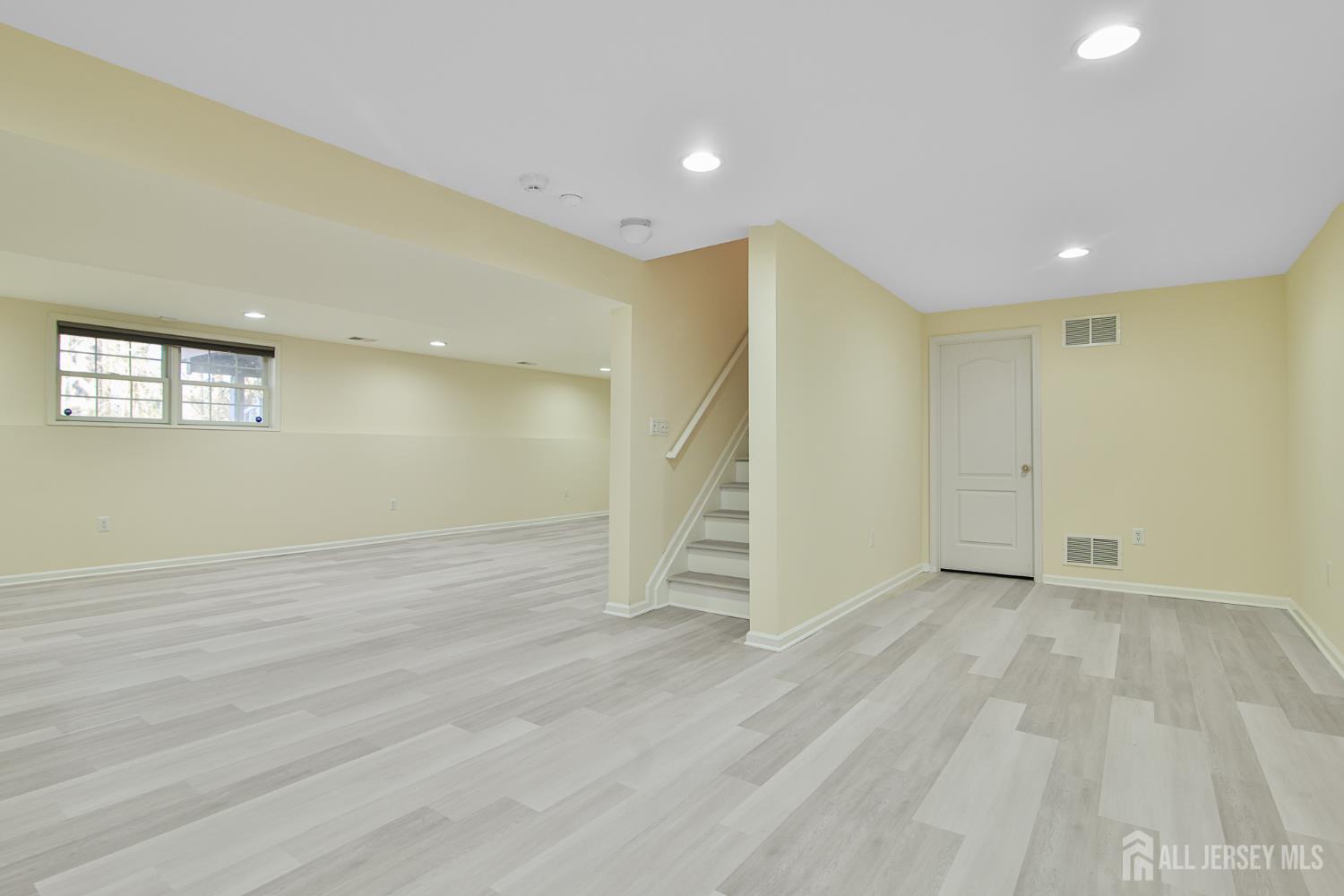 4 Timber Grove Court Old Bridge, NJ 08857 - Photo 18 of 20 an empty room with wooden floor and windows