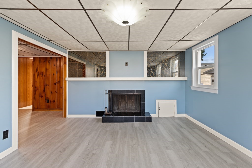 97 River Street Lynn, MA 01905 - Photo 11 of 30 a view of empty room with a fireplace and chandelier fan