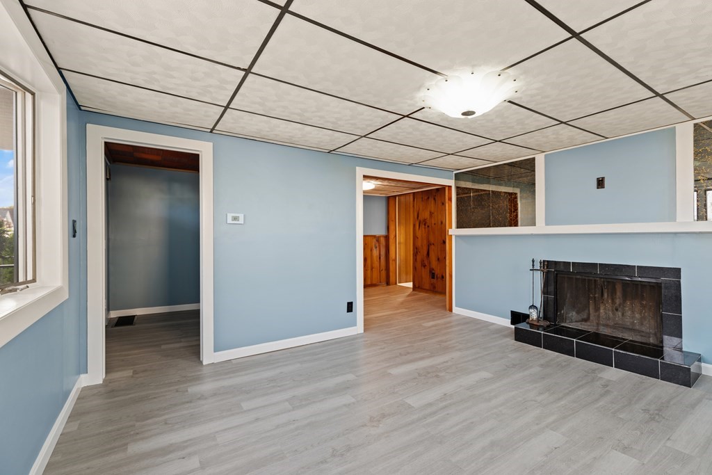 97 River Street Lynn, MA 01905 - Photo 12 of 30 a view of empty room with wooden floor and fireplace