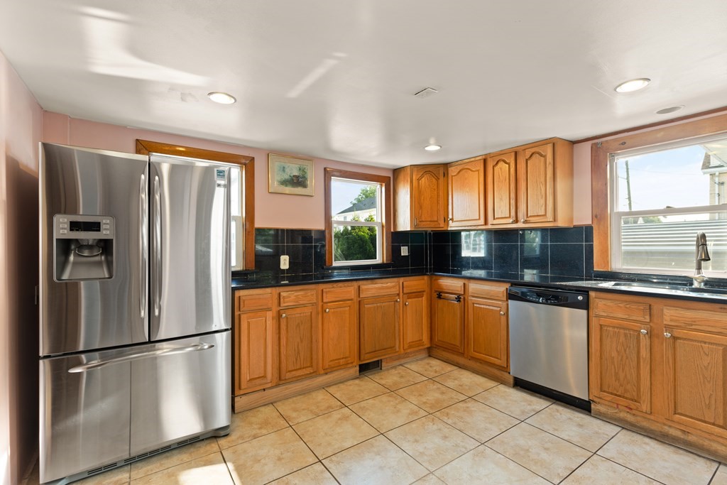 97 River Street Lynn, MA 01905 - Photo 19 of 30 a kitchen with granite countertop stainless steel appliances a refrigerator sink and microwave