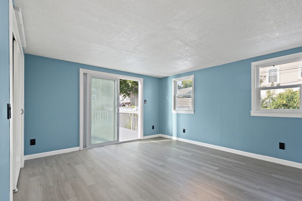 97 River Street Lynn, MA 01905 - Photo 20 of 30 an empty room with wooden floor and windows