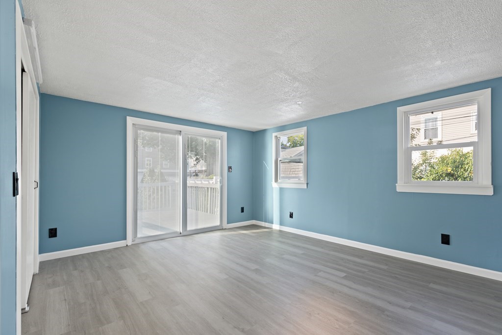 97 River Street Lynn, MA 01905 - Photo 21 of 30 a view of an empty room with wooden floor and a window