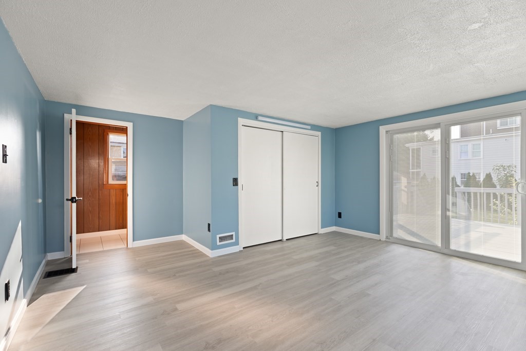 97 River Street Lynn, MA 01905 - Photo 22 of 30 a view of an empty room with wooden floor and a window