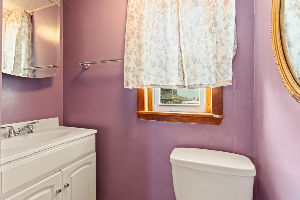 97 River Street Lynn, MA 01905 - Photo 26 of 30 a bathroom with a toilet sink and mirror