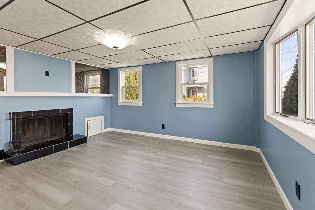 97 River Street Lynn, MA 01905 - Photo 10 of 30 a view of an empty room with a fireplace and a window