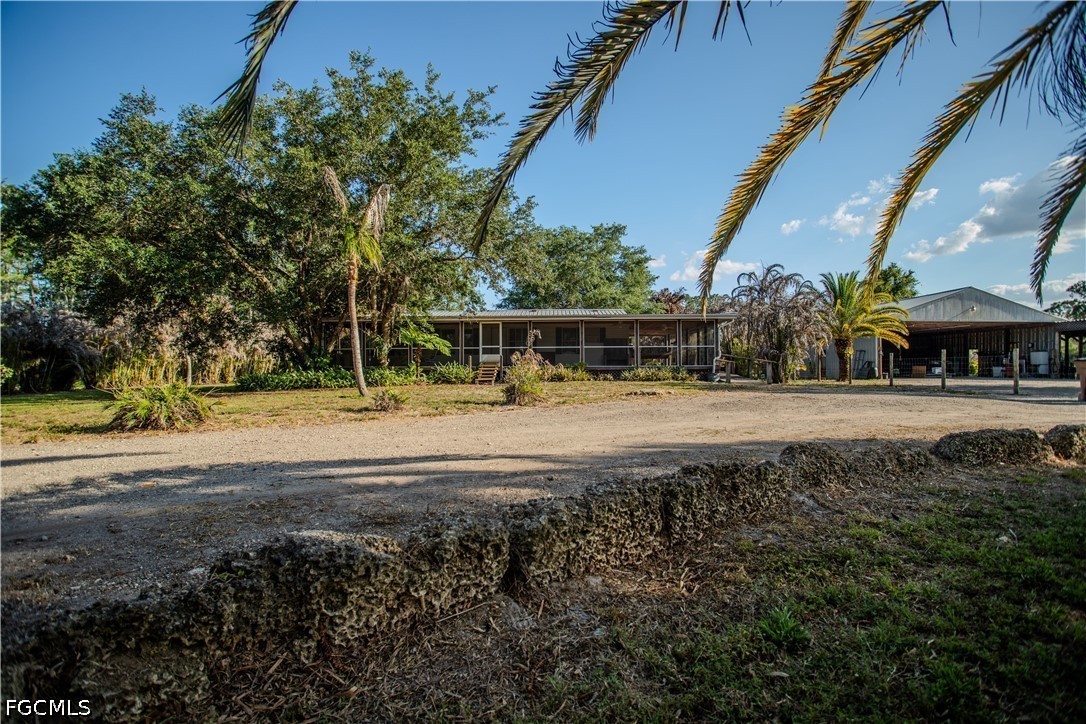 3880 Packinghouse Road Alva, FL 33920 - Photo 25 of 29 a view of swimming pool with lawn chairs and plants