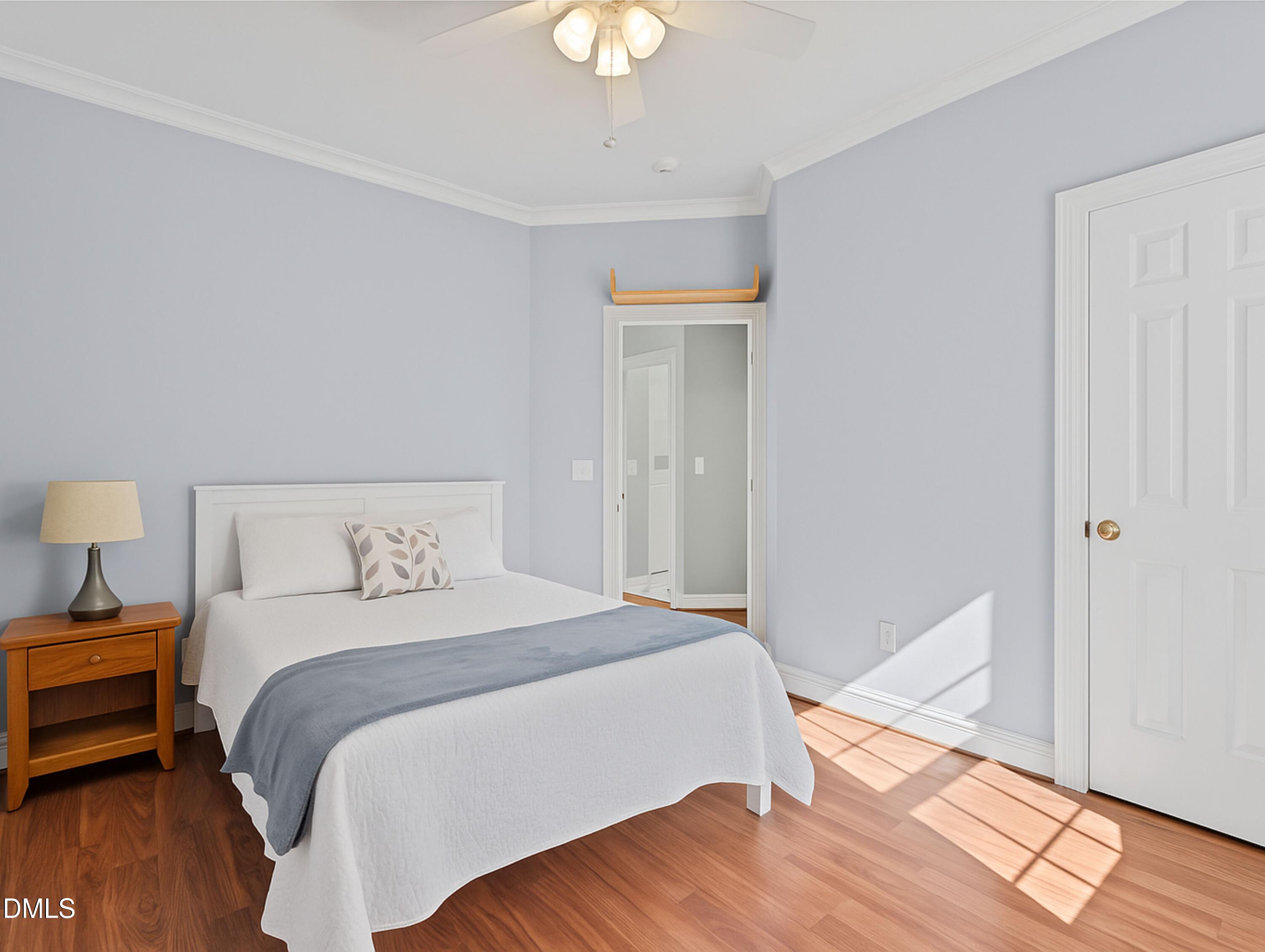 5870 Hoyt Road Middlesex, NC 27557 - Photo 18 of 33 a bedroom with a bed and a chandelier