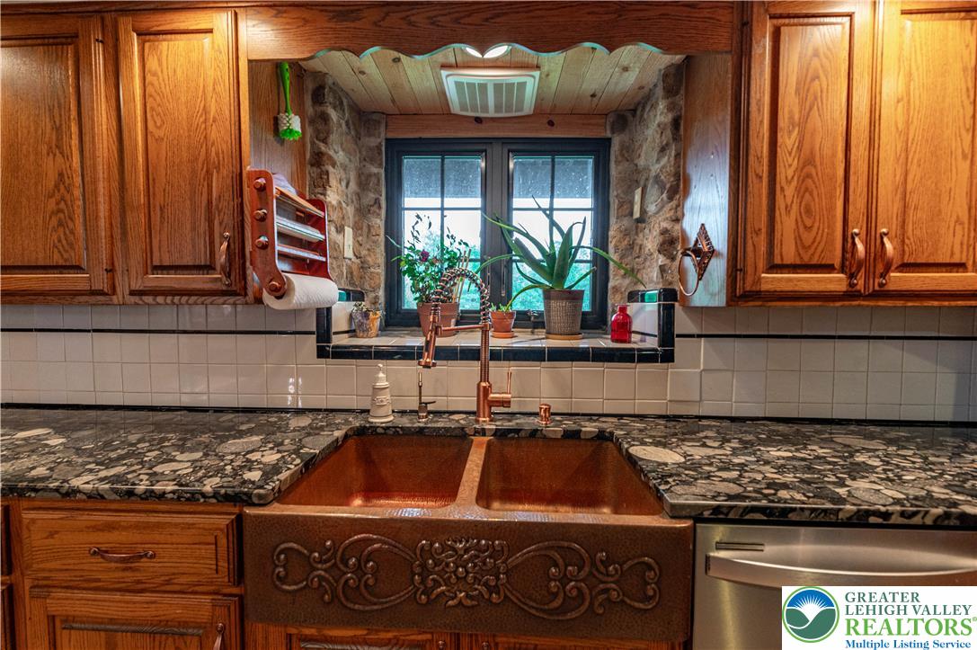 2485 Hieter Road Quakertown, PA 18951 - Photo 15 of 97 A warm kitchen features a distinctive copper farmhouse sink and stone accents.