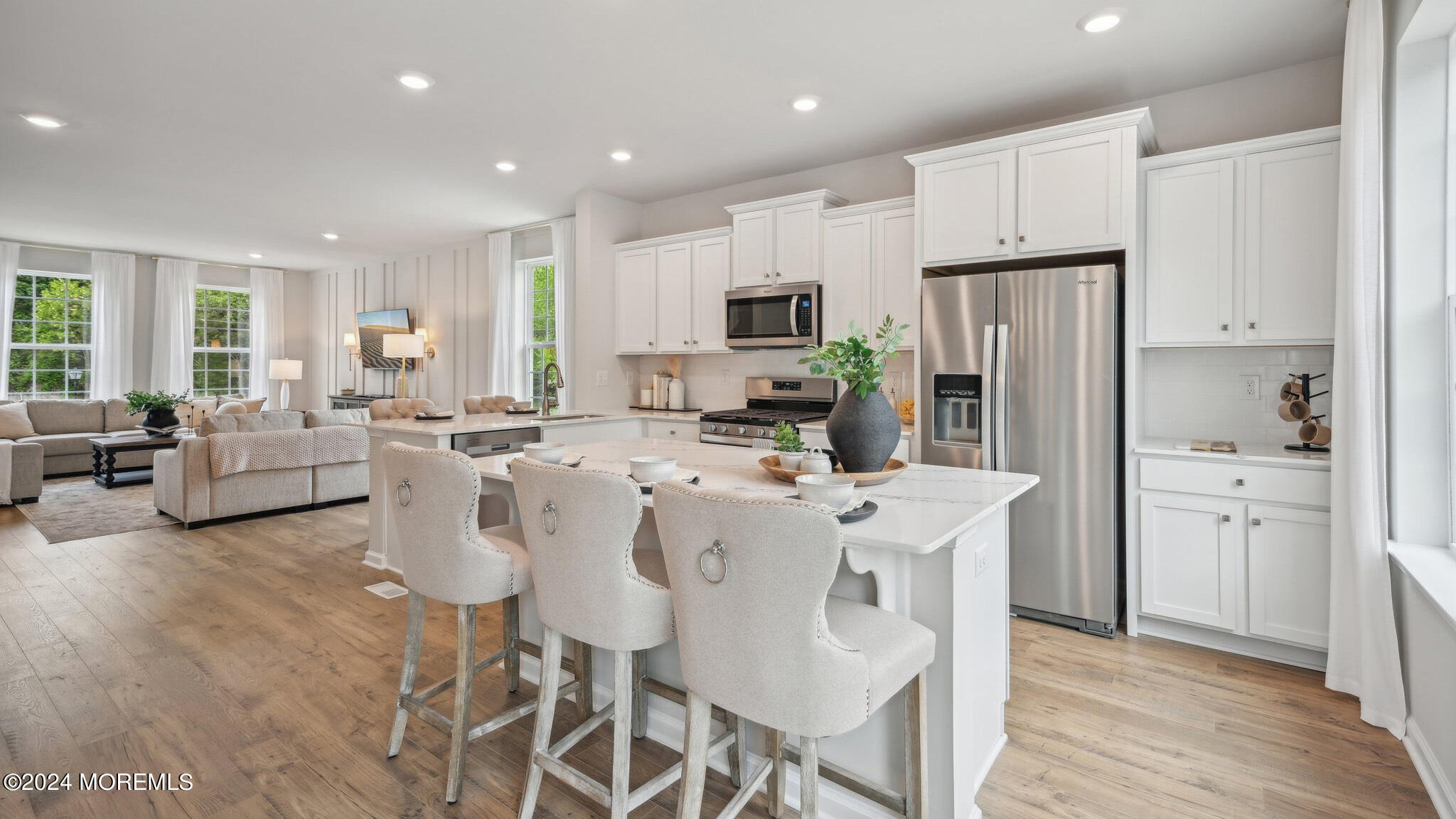 8 Rothbury Court Tinton Falls, NJ 07753 - Photo 19 of 43 a kitchen with stainless steel appliances a refrigerator a stove a dining table and chairs