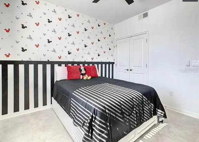 a bedroom with a bed and a large window