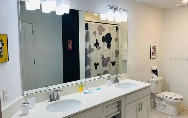 a bedroom with a large bed and a flat screen tv