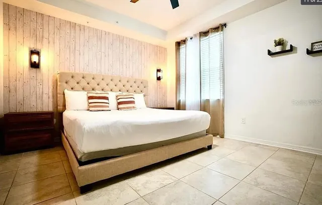 a bedroom with a bed and a flat screen tv