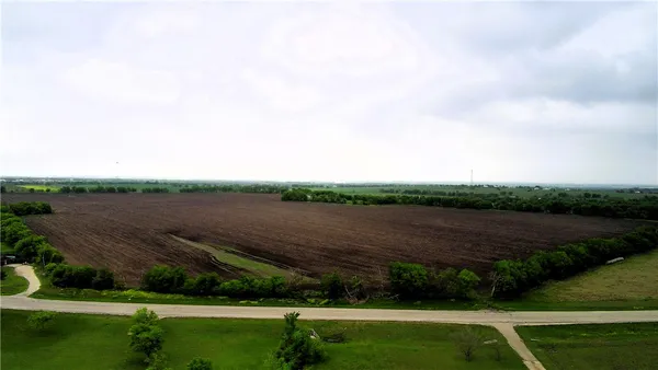 a view of a green field with an outdoor space