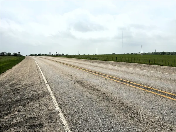 a view of a road with a yard