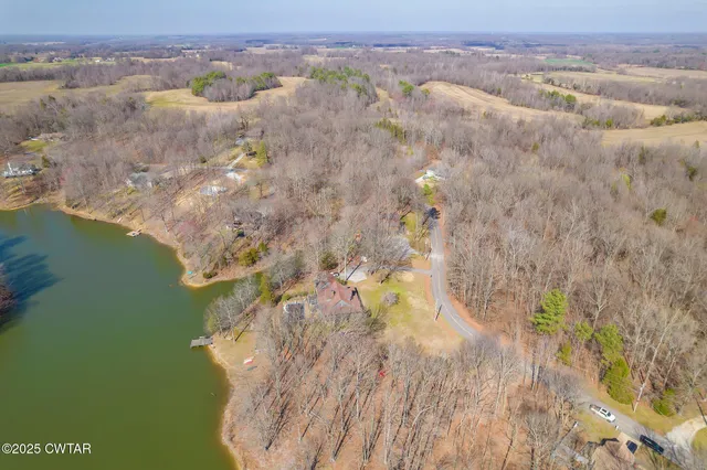 an aerial view of a houses with a yard