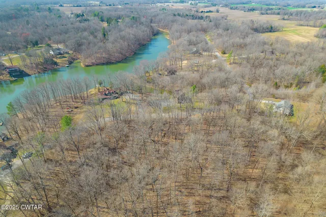 a bird view of house next to a yard