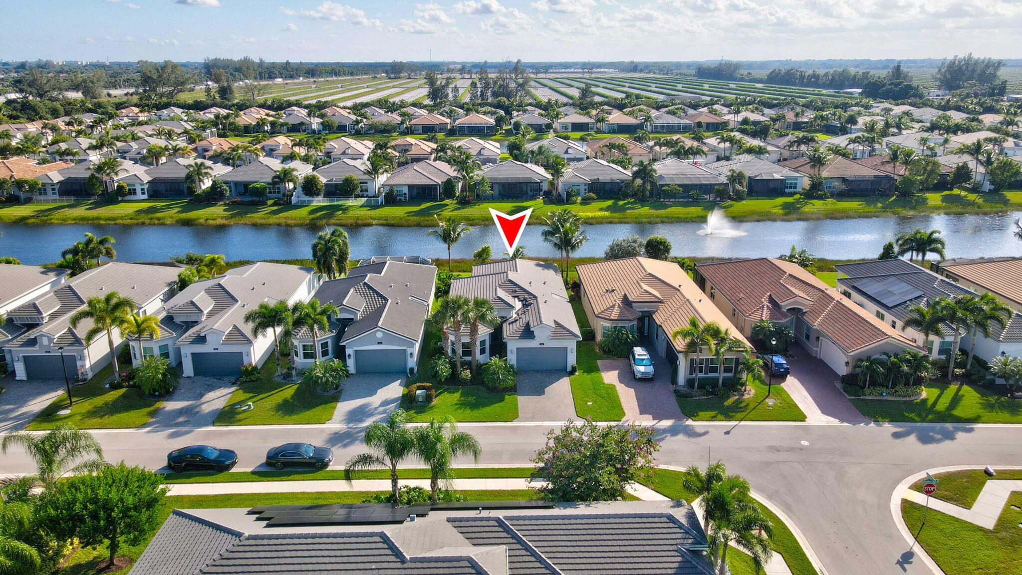 an aerial view of residential houses with outdoor space and swimming pool