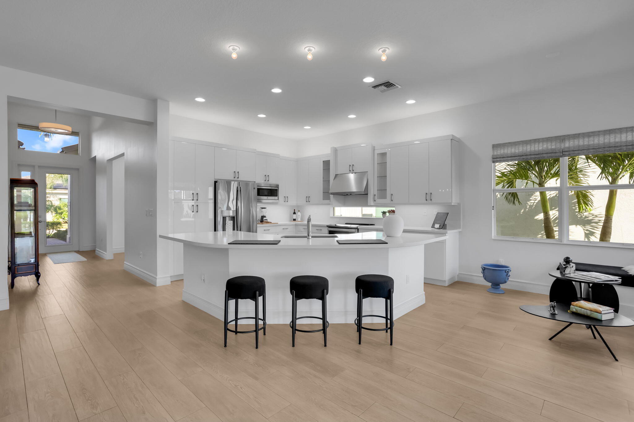 8254 Appalachian Ridge Road Boynton Beach, FL 33473 - Photo 13 of 50 a living room with kitchen island furniture a rug kitchen view and a window