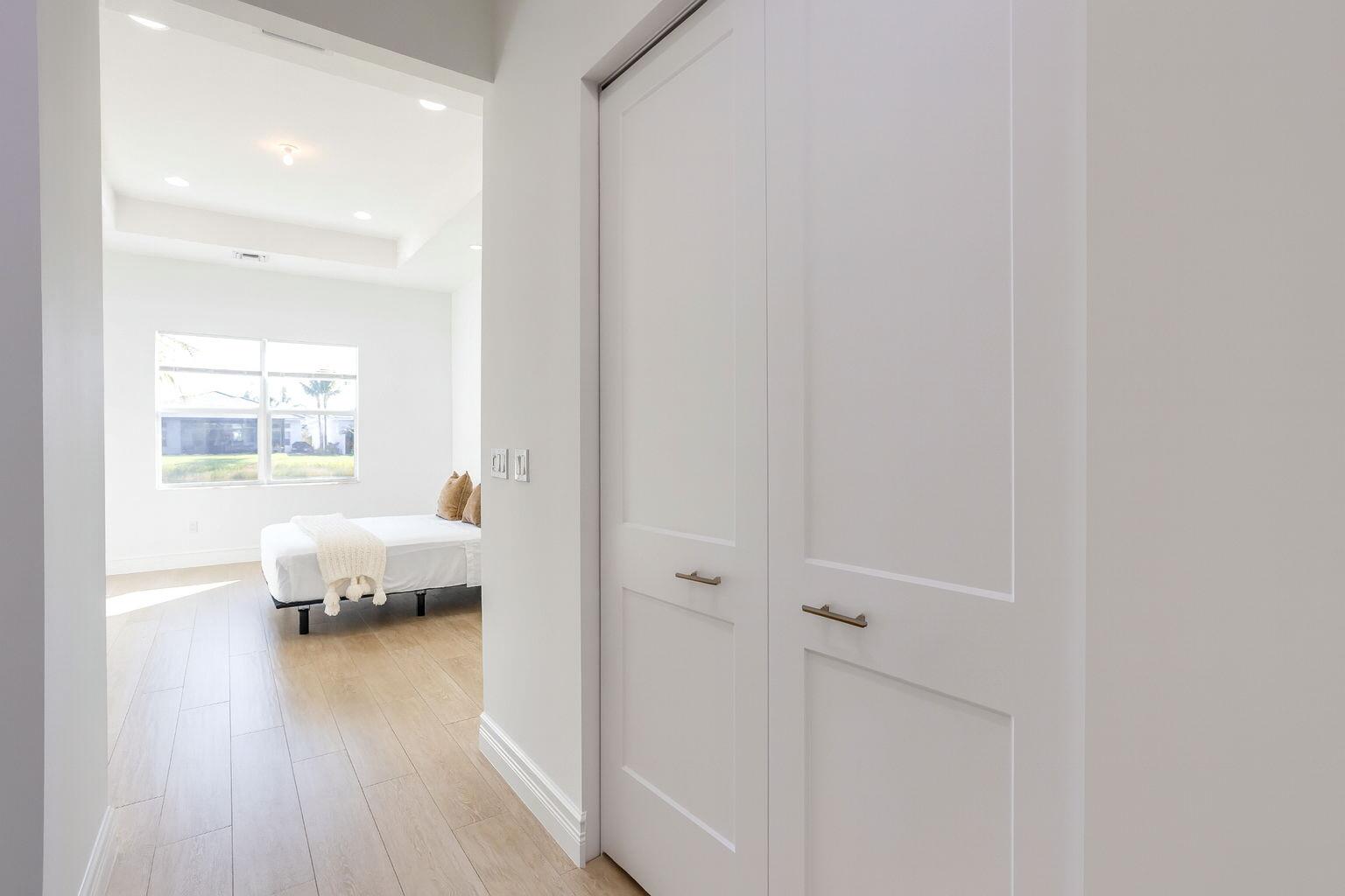 8254 Appalachian Ridge Road Boynton Beach, FL 33473 - Photo 16 of 50 a bedroom with a bed and wooden floor