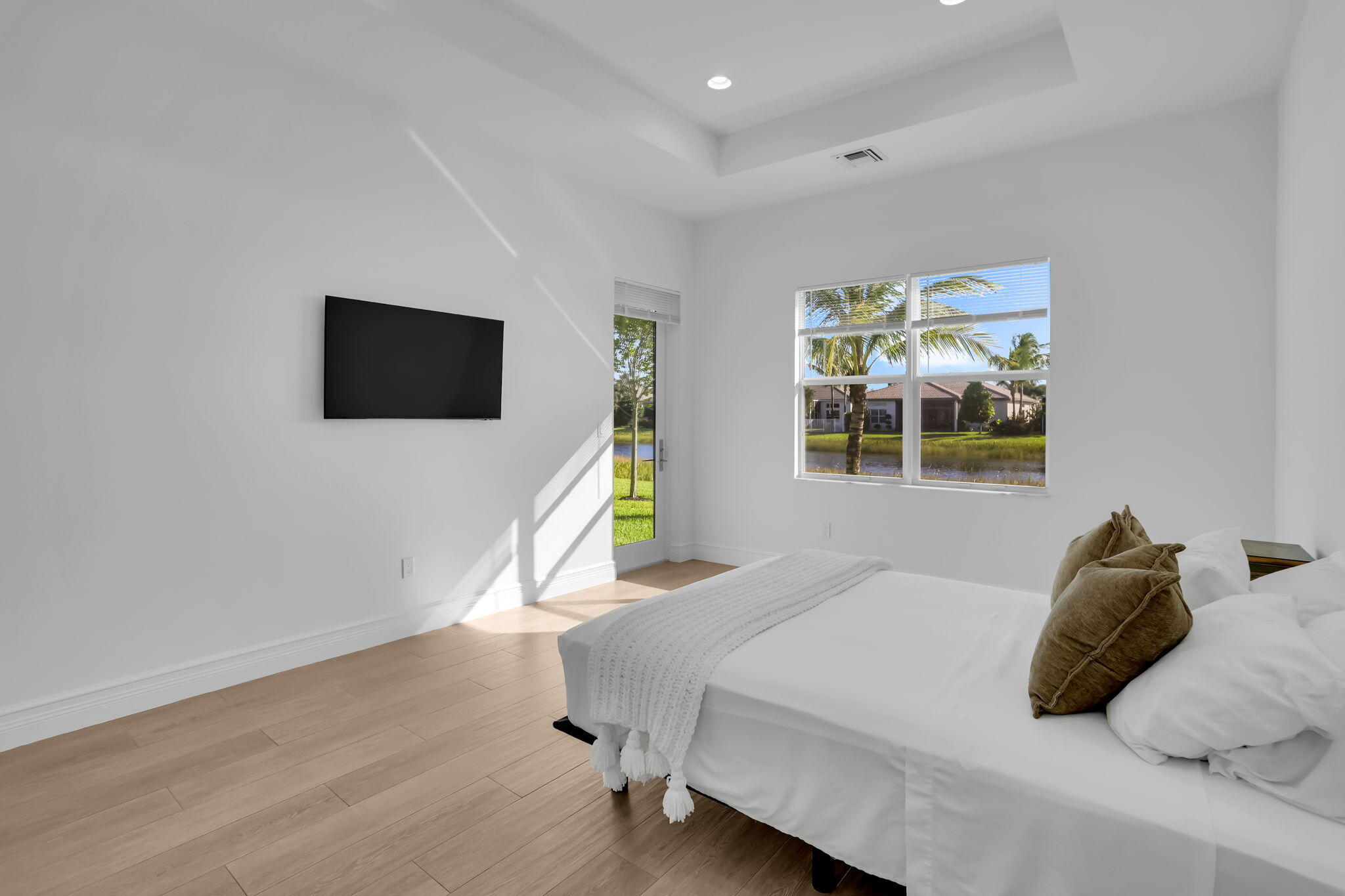 8254 Appalachian Ridge Road Boynton Beach, FL 33473 - Photo 17 of 50 a bedroom with a bed and a flat screen tv
