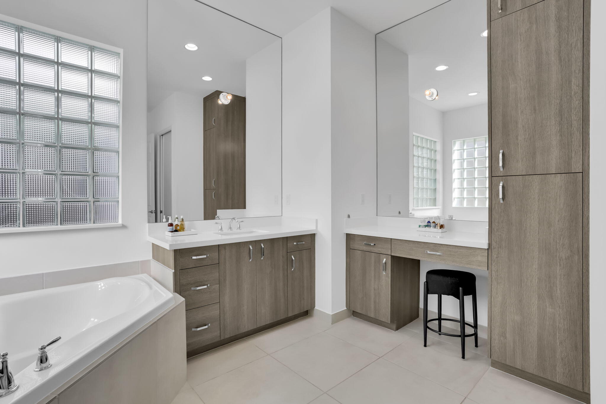 8254 Appalachian Ridge Road Boynton Beach, FL 33473 - Photo 20 of 50 a bathroom with a double vanity sink bathtub and next to a window