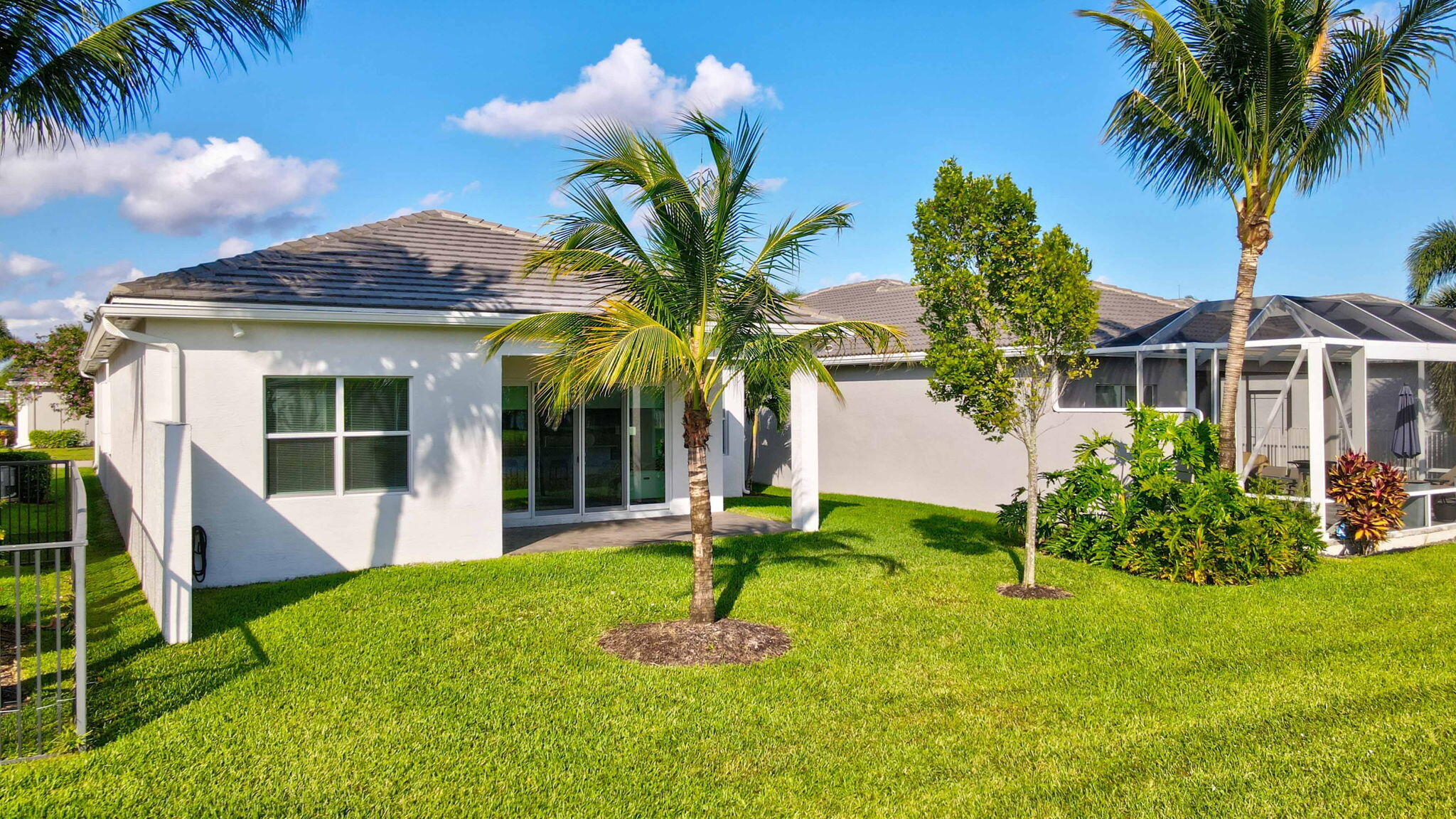 8254 Appalachian Ridge Road Boynton Beach, FL 33473 - Photo 33 of 50 a front view of a house with a yard and palm trees
