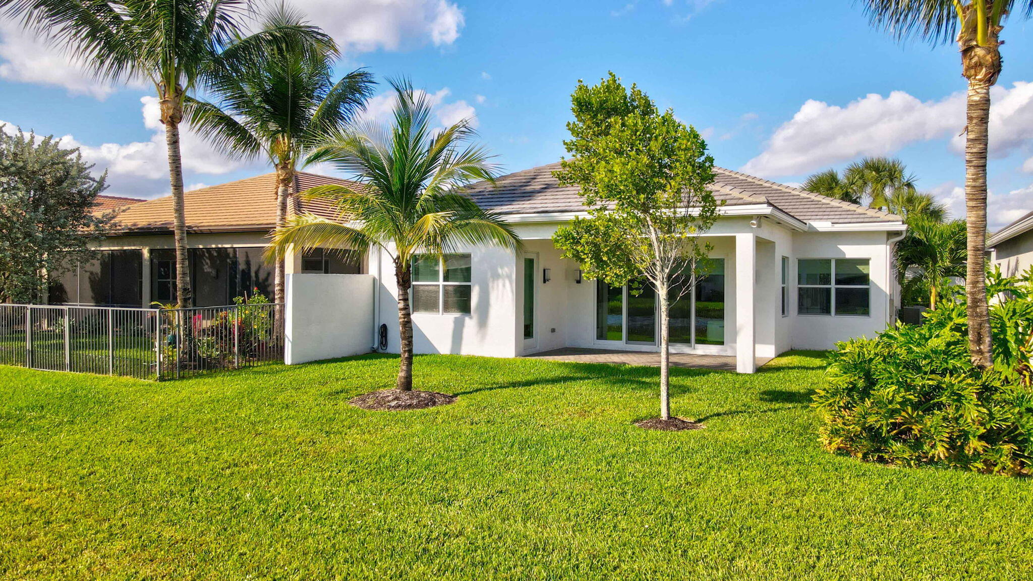 8254 Appalachian Ridge Road Boynton Beach, FL 33473 - Photo 34 of 50 a house with palm tree in front of it