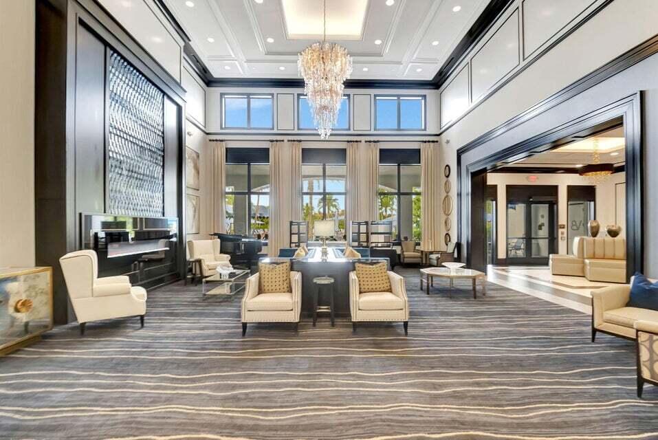 8254 Appalachian Ridge Road Boynton Beach, FL 33473 - Photo 38 of 50 a living room with fireplace furniture and a chandelier