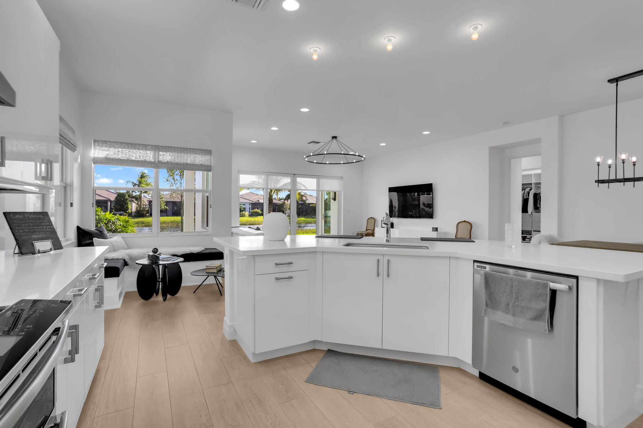 8254 Appalachian Ridge Road Boynton Beach, FL 33473 - Photo 10 of 50 a large white kitchen with lots of counter top space a sink a window and stainless steel appliances