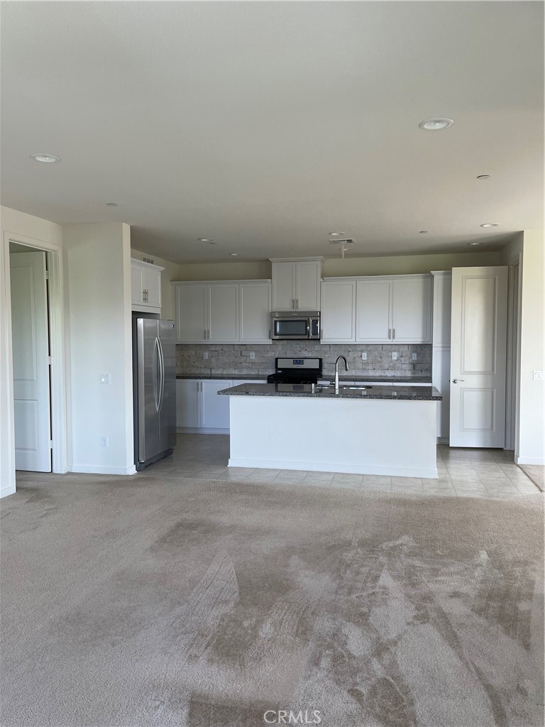 609 Trailblaze Irvine, CA 92618 - Photo 14 of 29 a view of a kitchen with refrigerator and a sink