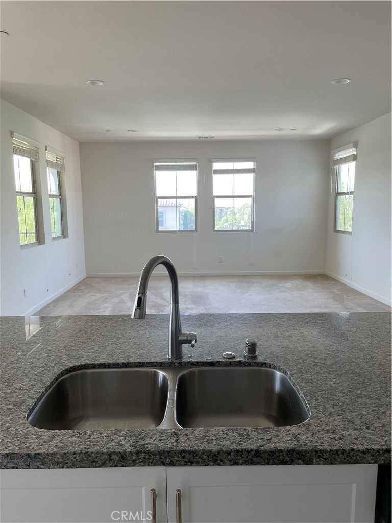 609 Trailblaze Irvine, CA 92618 - Photo 15 of 29 a kitchen with granite countertop a sink and a window