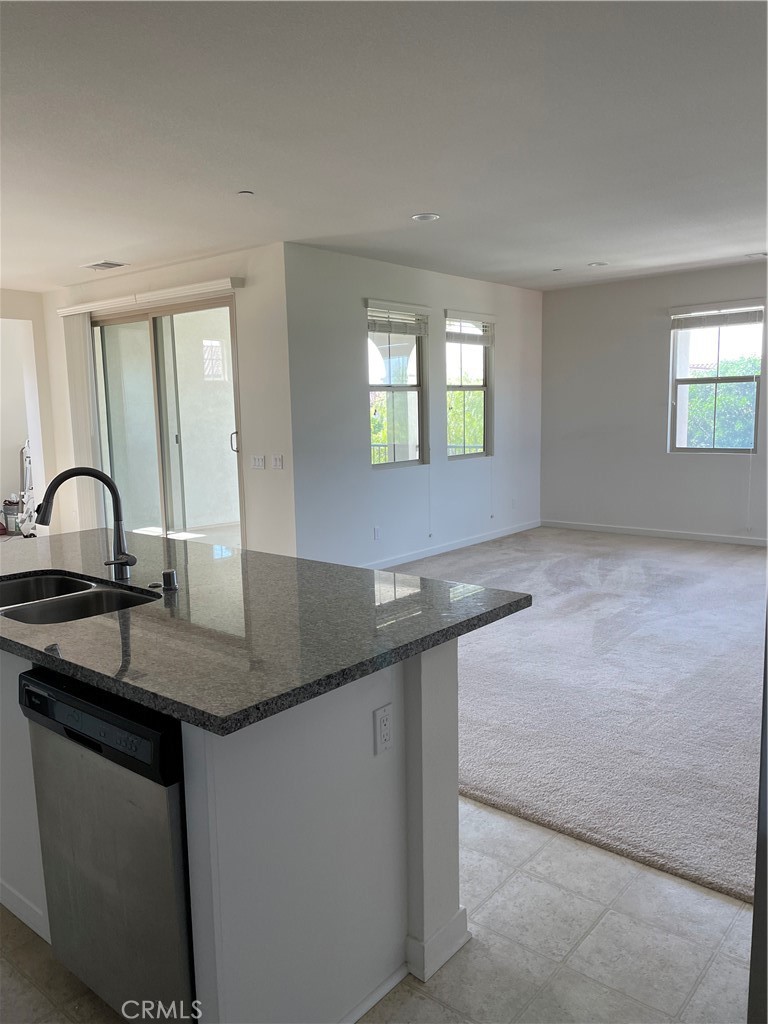 609 Trailblaze Irvine, CA 92618 - Photo 16 of 29 a kitchen with granite countertop a sink and a stove