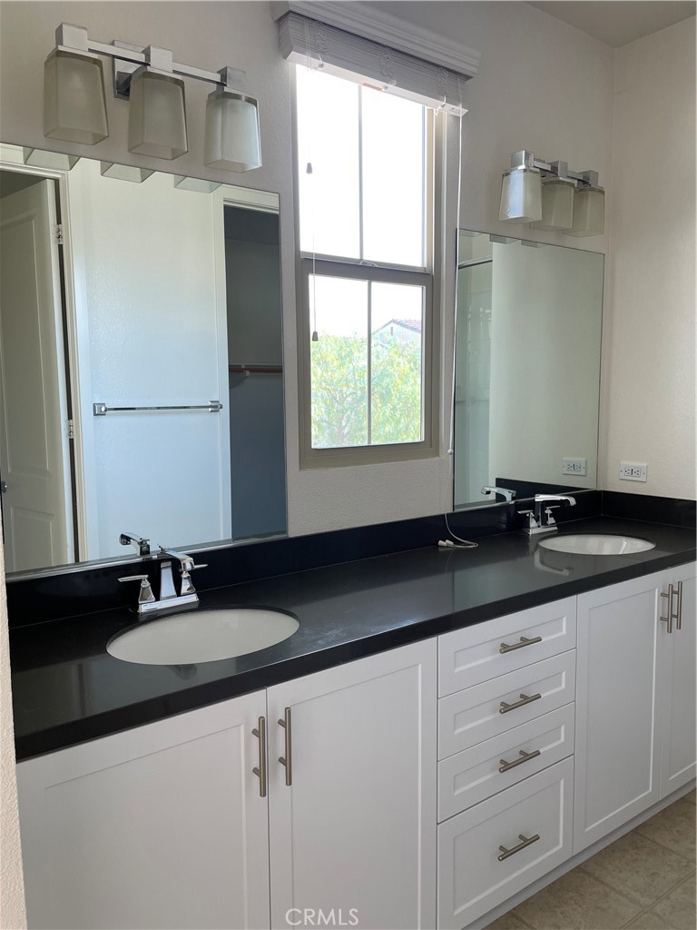609 Trailblaze Irvine, CA 92618 - Photo 19 of 29 a bathroom with a granite countertop sink and a mirror
