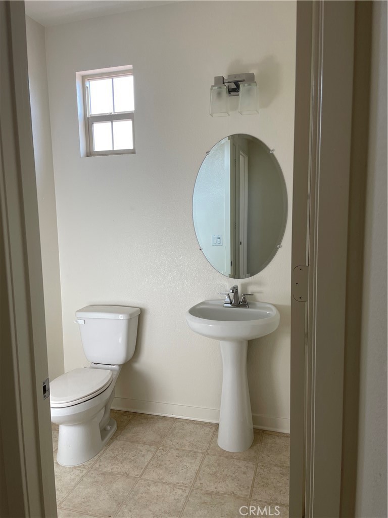 609 Trailblaze Irvine, CA 92618 - Photo 28 of 29 a bathroom with a toilet sink and mirror